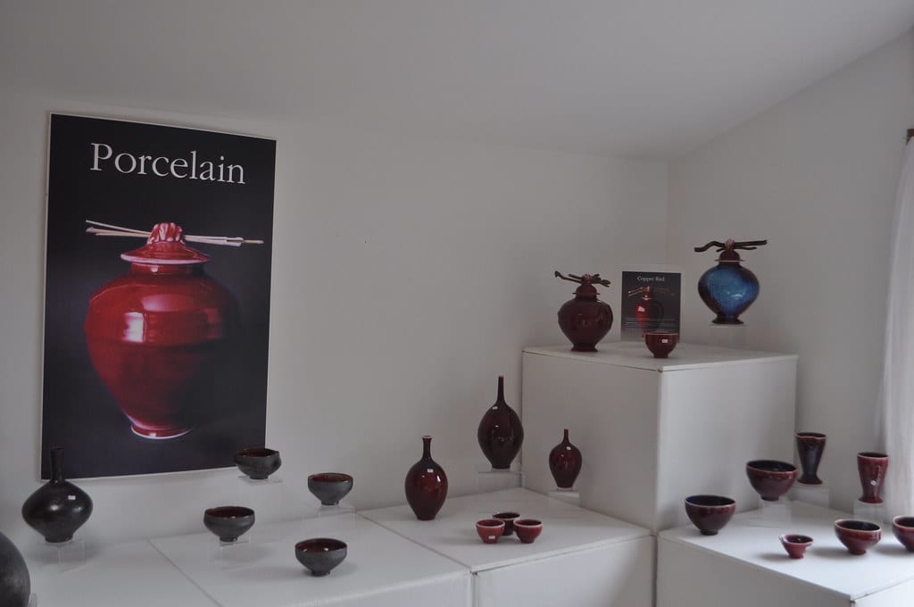A display of finished copper-red and blue glazed porcelain vessels and bowls