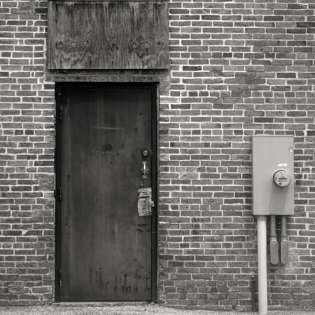 A residential electricity meter mounted on an exterior wall