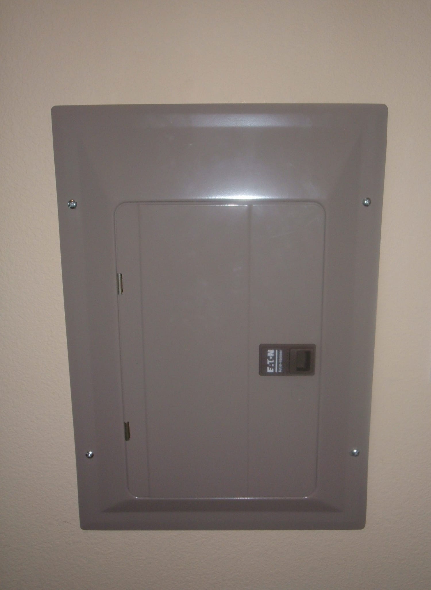 An open residential circuit breaker panel showing rows of breakers