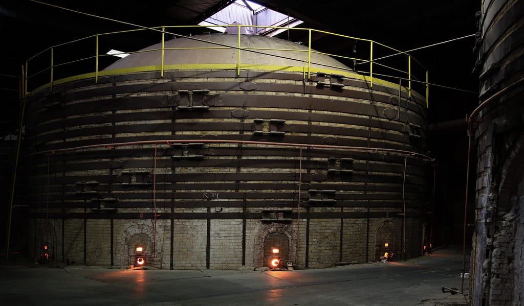 A kiln at high temperature glowing orange through its spy holes
